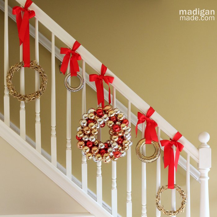 appealing-home-interior-decor-ideas-with-slanted-white-wooden-stairs-added-with-monotone-banister-and-hanging-colorful-balls-sleek-christmas-wreath-on-red-ribbon-hanger1