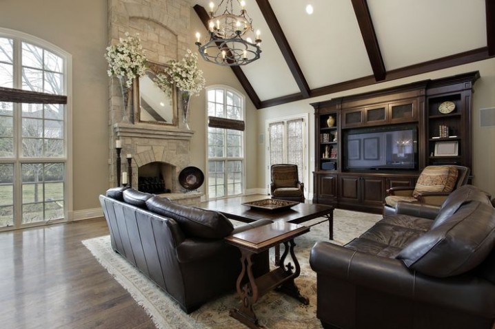 Family room in luxury home with two story stone fireplace