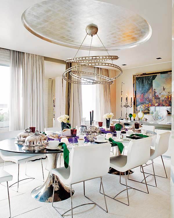 colorfull-and-happy-dining-room-with-unique-lamp-and-metal-chair-and-oval-table-with-centerpiece-also-cool-picture-and-glass-windows