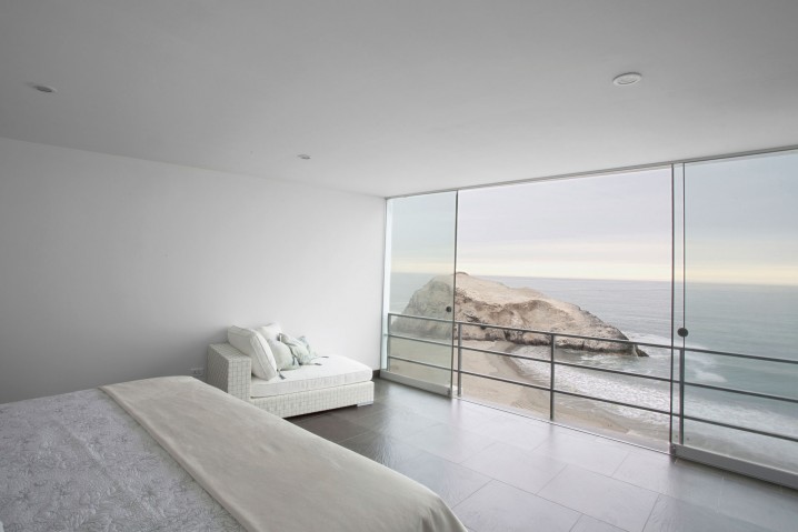 Exciting-White-Interior-of-Floor-to-Ceiling-Windows-in-Minimalist-Bedroom-with-Glass-Sliding-Doors-Completed-with-Bed-and-Sleeper-Chairs-Furnished-by-Cushions