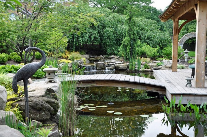 Custom-Asian-landscape-design-with-waterfall-pond-and-a-bride-leading-to-the-pavilion