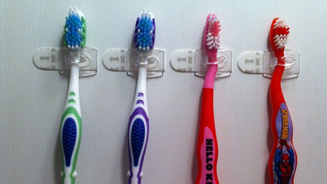 command hooks as toothbrush holders