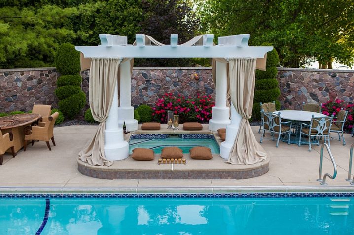 a-fabulous-outdoor-space-promises-a-soothing-dip-in-the-hot-tub-by-the-pool