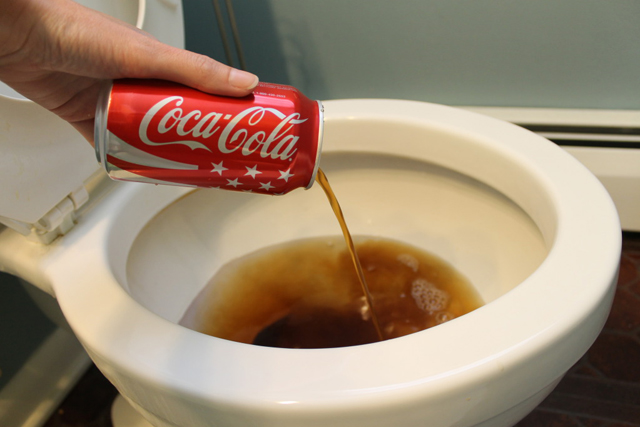 clean toilet with cola