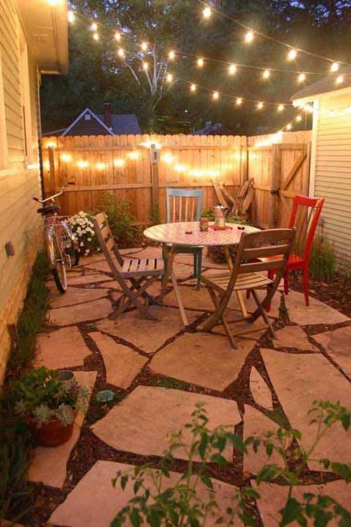 Flagstone-Patio-for-Small-Garden-Design-with-Unique-Hanging-Lights-String-and-Wooden-Fences