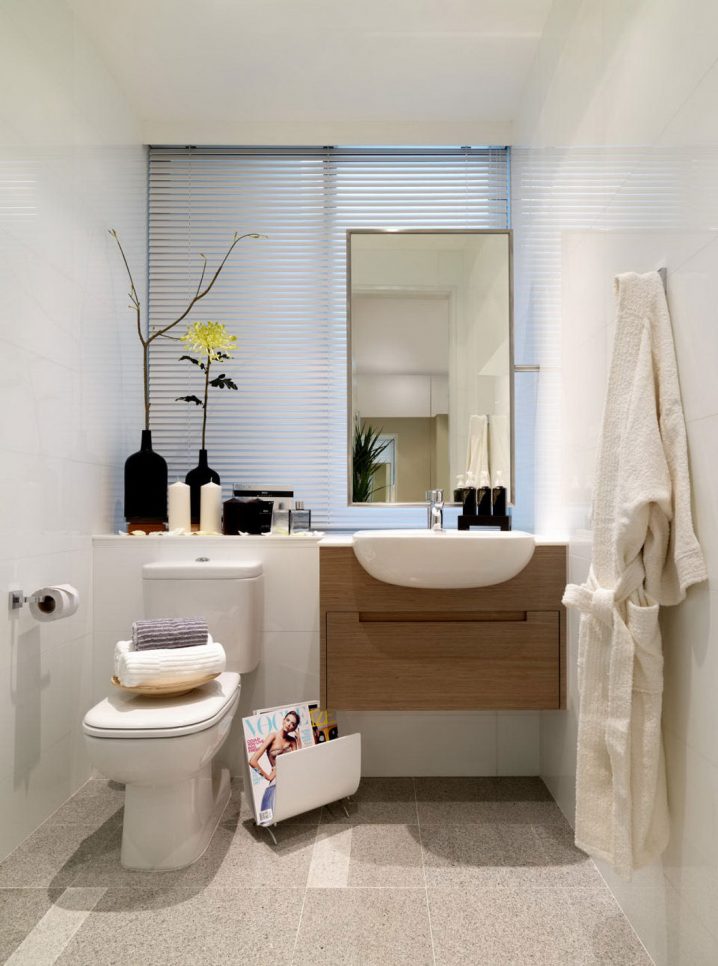 fabulous-lighting-above-small-bathroom-vanity-and-white-sink-beside-white-tile-wall