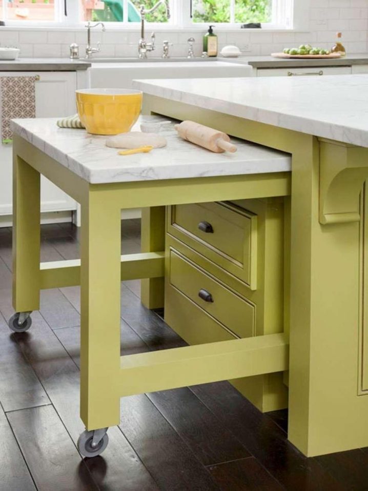 a-charming-green-sliding-table-and-kitchen-island-in-kitchen-with-hardwood-flooring