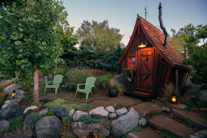 pretty-little-tikes-playhouse-in-landscape-rustic-with-storage-shed-next-to-garden-shed-alongside-hobbit-house-andgravel-between-pavers