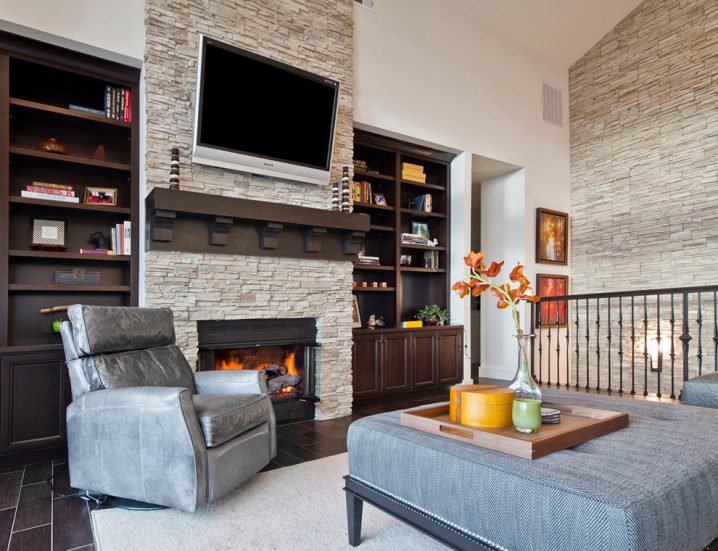 stacked-stone-fireplaces-in-living-room-transitional-with-corbels-bookcases-3